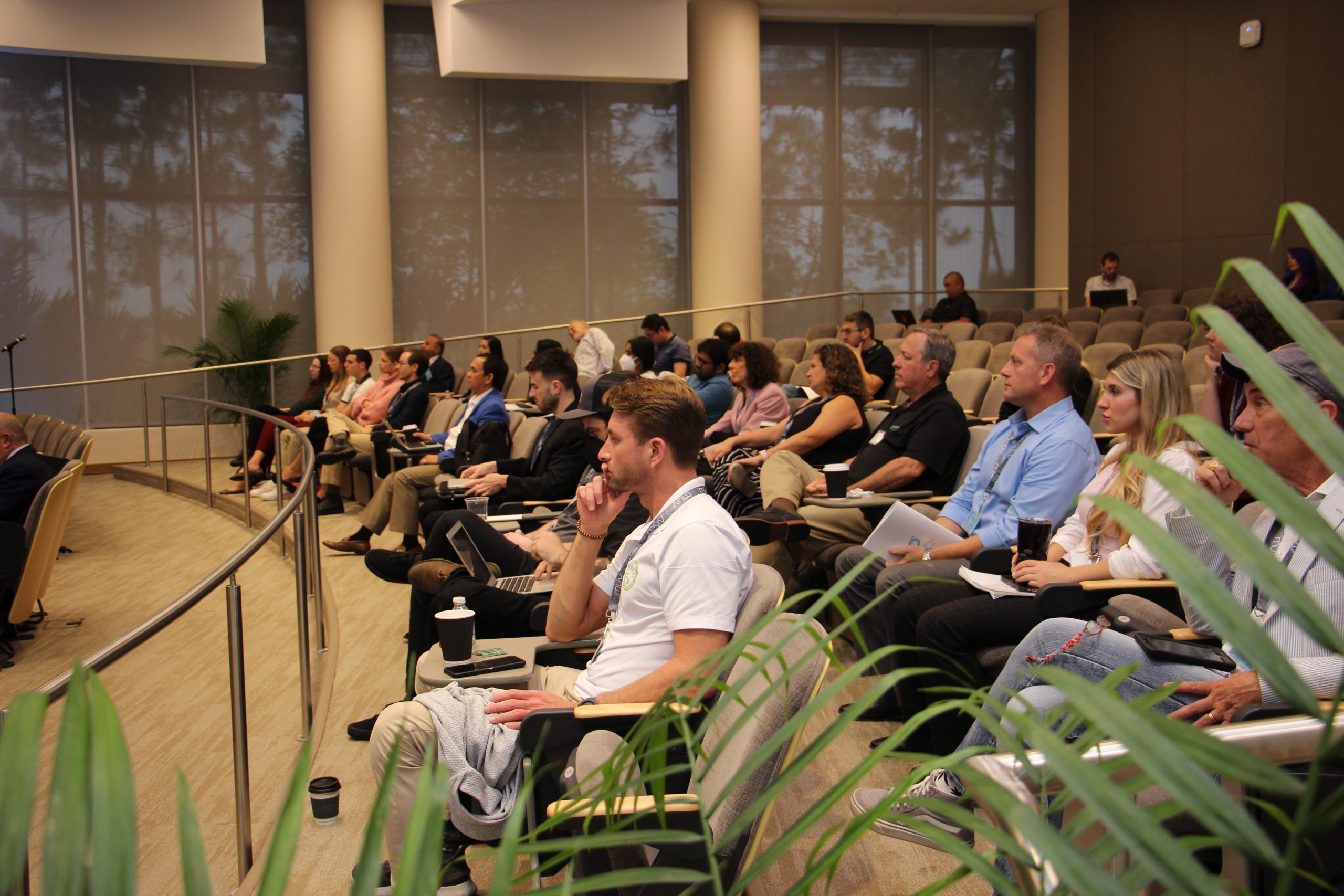 An audience of attendees sitting in a lecture hall