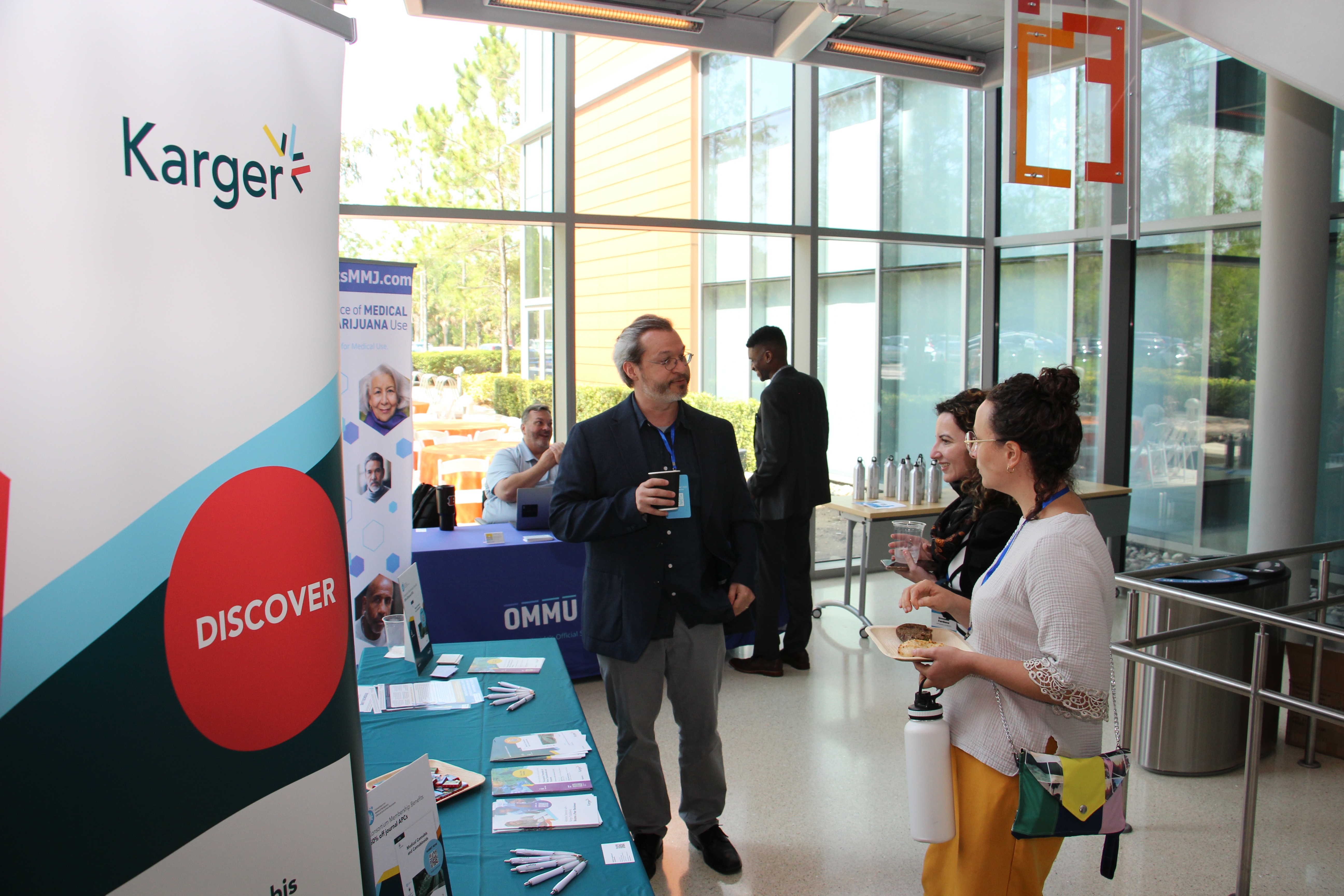 Exhibitors interacting with attendees at CCORC 2025.